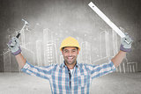 Composite image of smiling handyman holding hammer and level