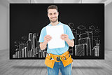 Composite image of construction worker showing blank paper on clipboard
