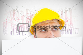 Composite image of repairman looking away while in front of billboard
