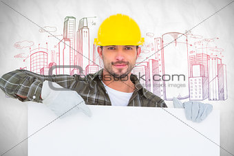Composite image of handyman holding and pointing at blank board