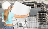 Young woman in white hard hat holding paper