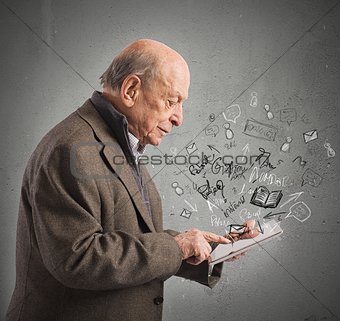Aged reads books with tablet