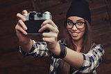 girl in glasses and braces with vintage camera