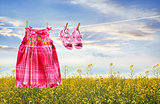 Dress and sandals on clothesline in summer