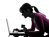 woman holding credit card computing laptop computer silhouette