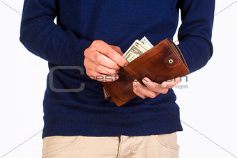 Man Holding a Wallet and Counting Dollars