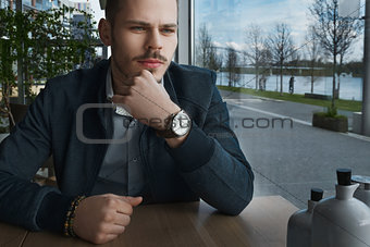 Man sitting inside posing