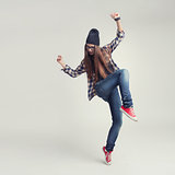 Dancing hipster girl in glasses and black beanie