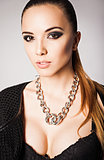 Fashion portrait of pretty young woman wearing bra and necklace 