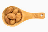 almond nuts on wooden spoon