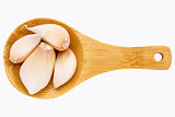 garlic cloves on wooden spoon