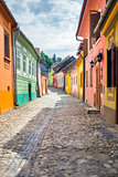 Stone paved old streets with colored houses from Sighisoara fort