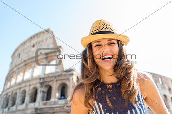 Happy woman tourist in Rome near Colosseum in summer
