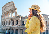 Woman in profile standing and looking into distance in Rome