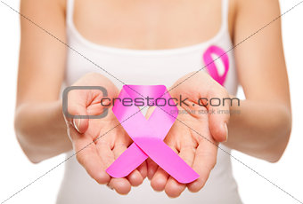 Woman holding a pink cancer awareness ribbon 