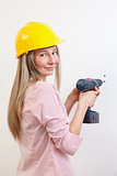 Woman doing the DIY work and wearing protective helmet
