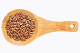 brown flax seeds on wooden spoon