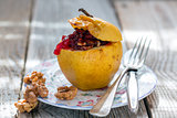Baked apple with nuts and cowberry.