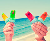 homemade ice pops on the beach, with a filter effect