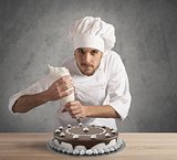 Pastry cook prepares a cake