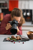 Woman photographer taking photos of autumn fruits and vegetables