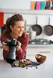 Smiling woman food photographer taking a break in kitchen