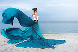 Beautiful Girl With  fabric on The Beach.