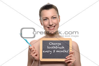 Bare woman holding toothbrush and empty board