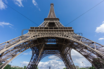The Eiffel Tower and Montparnasse tower over blue sky