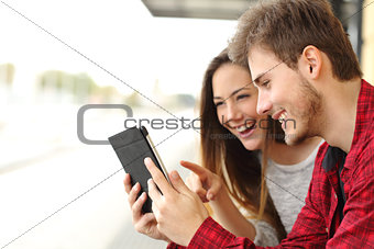 Couple sharing media content from a tablet