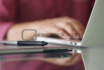 Designer Using Grafic Tablet And Laptop Writes On Keyboard 