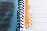 X-ray examination and copy book with pencil