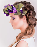 Side view of a girl with flower crown posing in studio