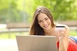 Shopper girl buying online with a laptop and credit card