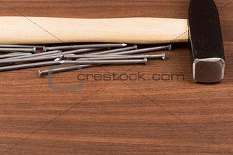 Hammer and nails on table