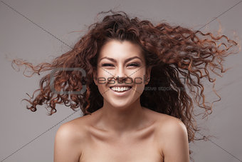 smiling woman with healthy brown curly hair
