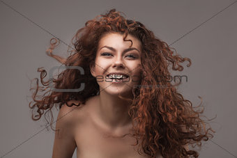 smiling woman with healthy brown curly hair