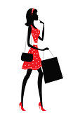 Silhouette of a woman shopping.
