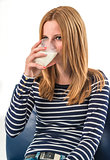 young woman drinking a glass of milk