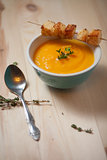 Bowl of pumpkin soup on  wood table