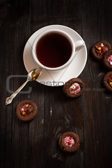 cup of coffee and cookie on wood table