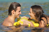 Couple in summer vacation bathing on the beach