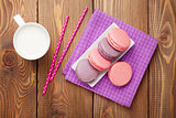 Colorful macaron cookies and cup of milk