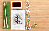 Sushi maki set with fresh sakura branch