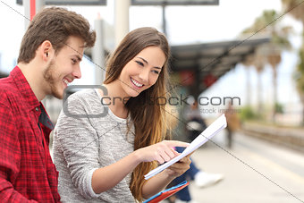 Couple of students studying in a train station