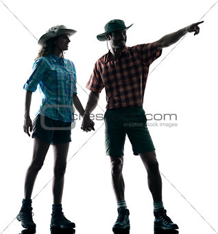 couple trekker trekking pointing nature silhouette