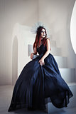 Gothic fashion: beautiful young girl in black dress and headwear