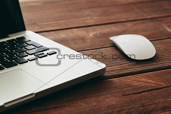 Close-up shot of laptop on old wooden desk
