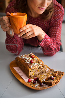 Closeup of woman's hands holding mug with home-made baking