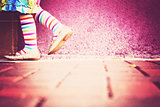 Whimsical Little Girl in Striped Tights
